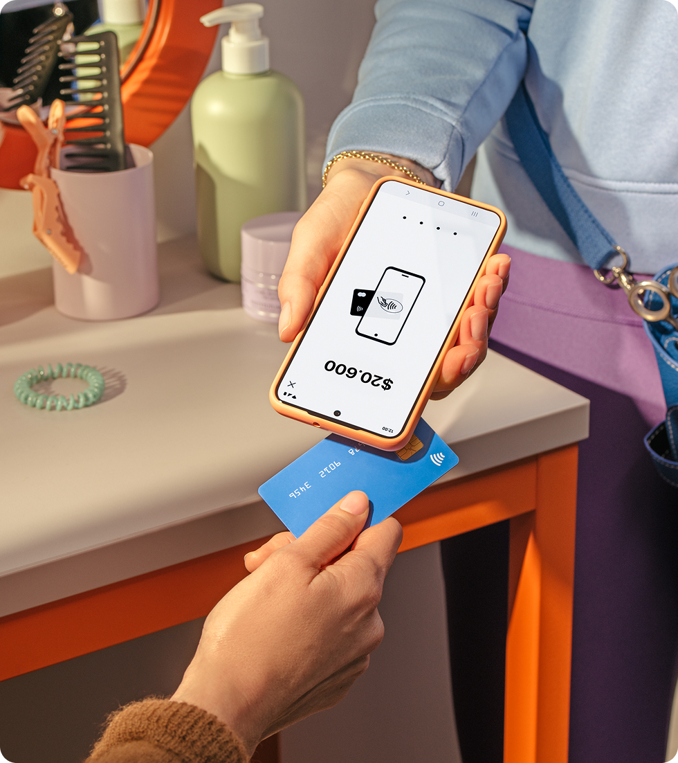 Person tapping their card on a smartphone