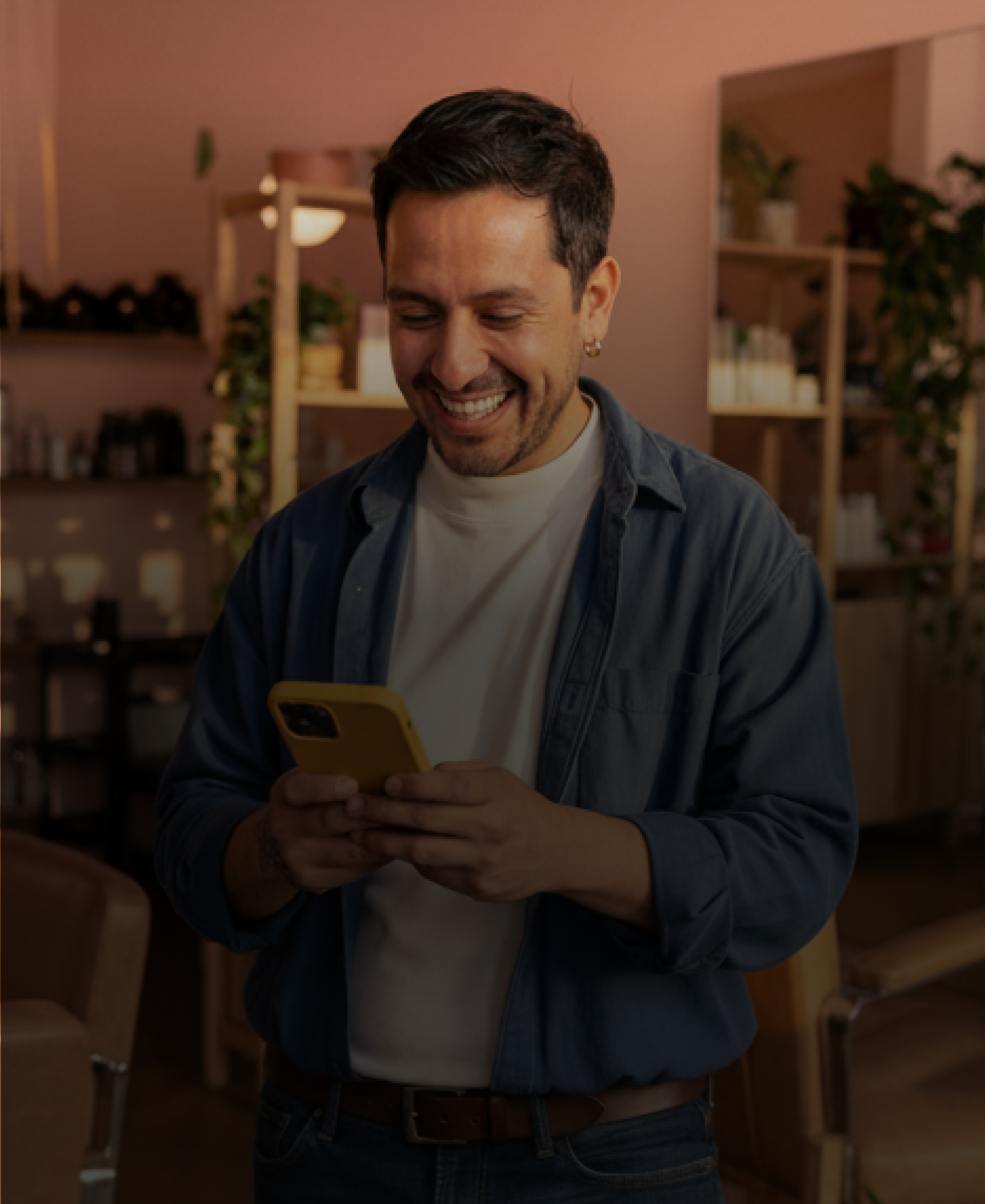 Man looking at his phone smiling