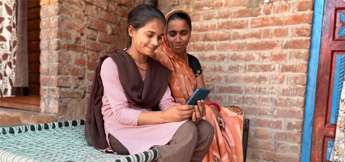 Mother and daughter in rural India using a mobile phone 
