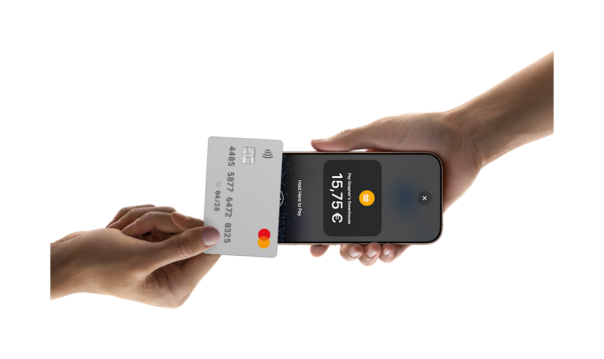 Someone tapping a card on a phone to pay for something