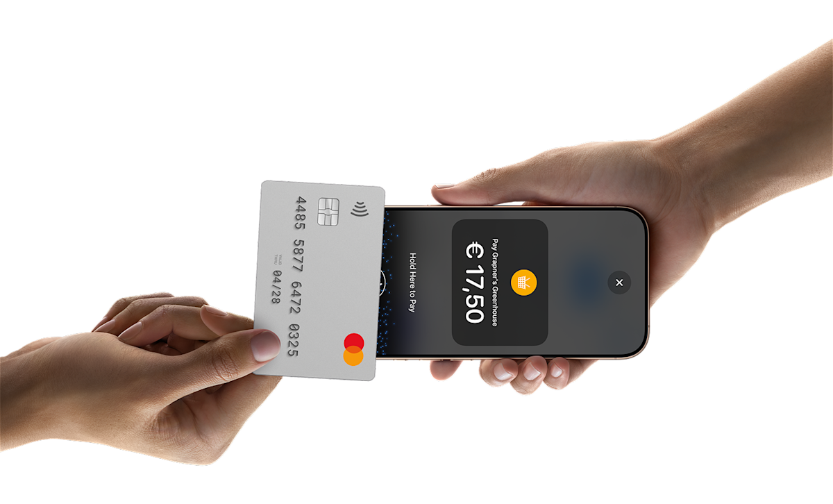 Someone tapping a card on a phone to pay for something