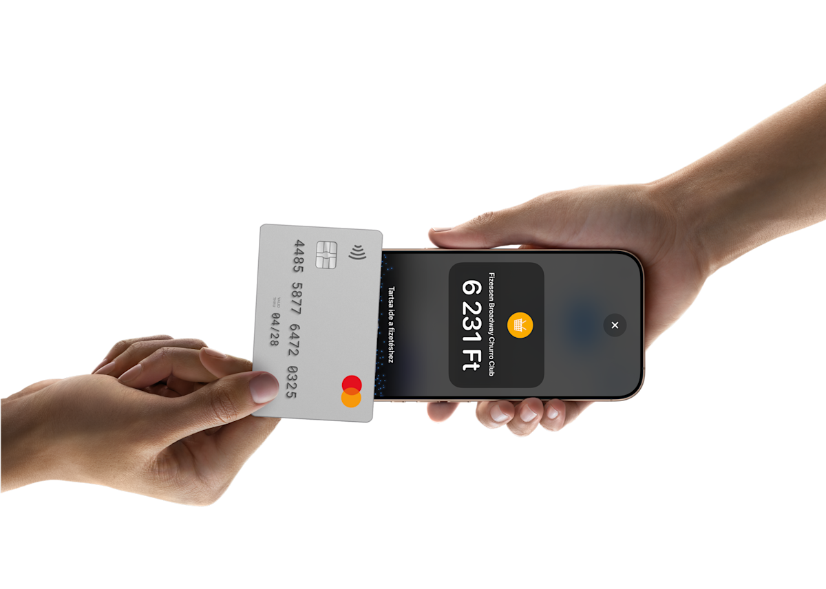 Someone tapping a card on a phone to pay for something