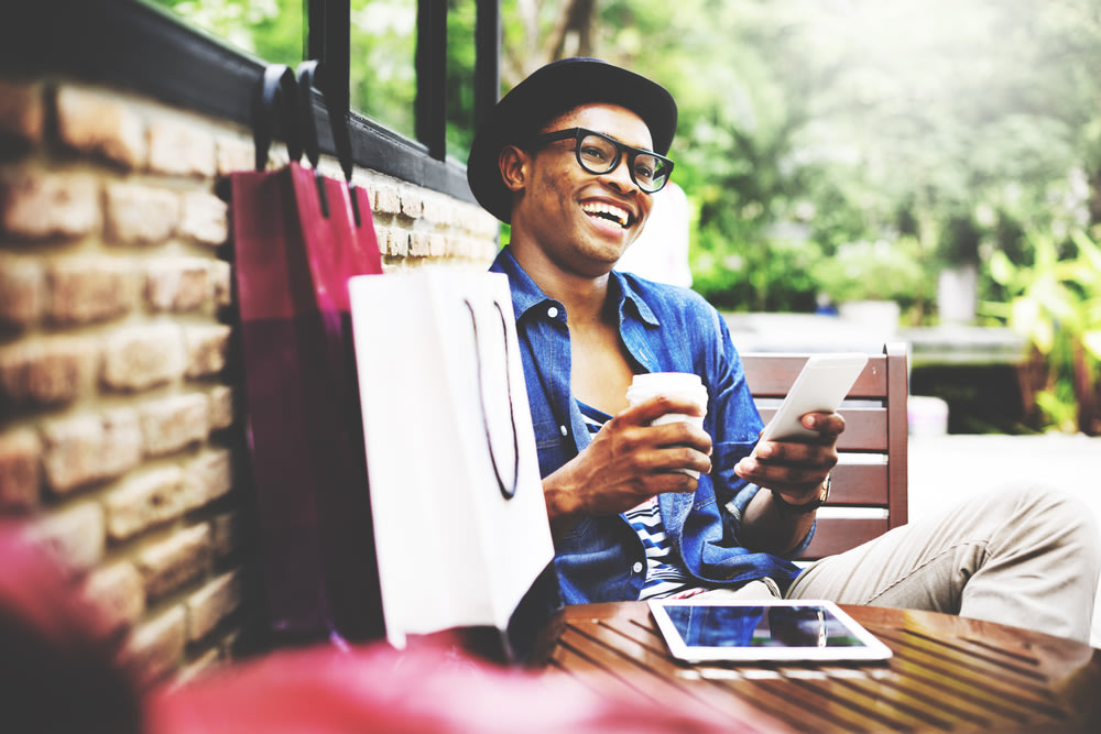 Happy male customer shopping on his phone