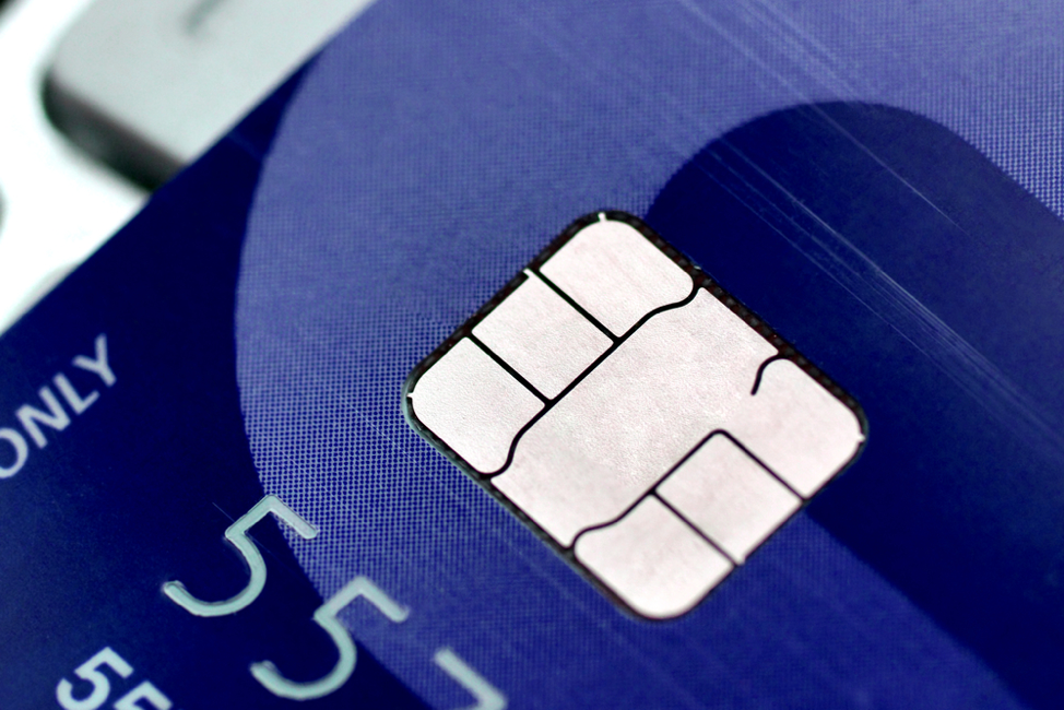 Close up image of a blue credit card with an EMV chip.