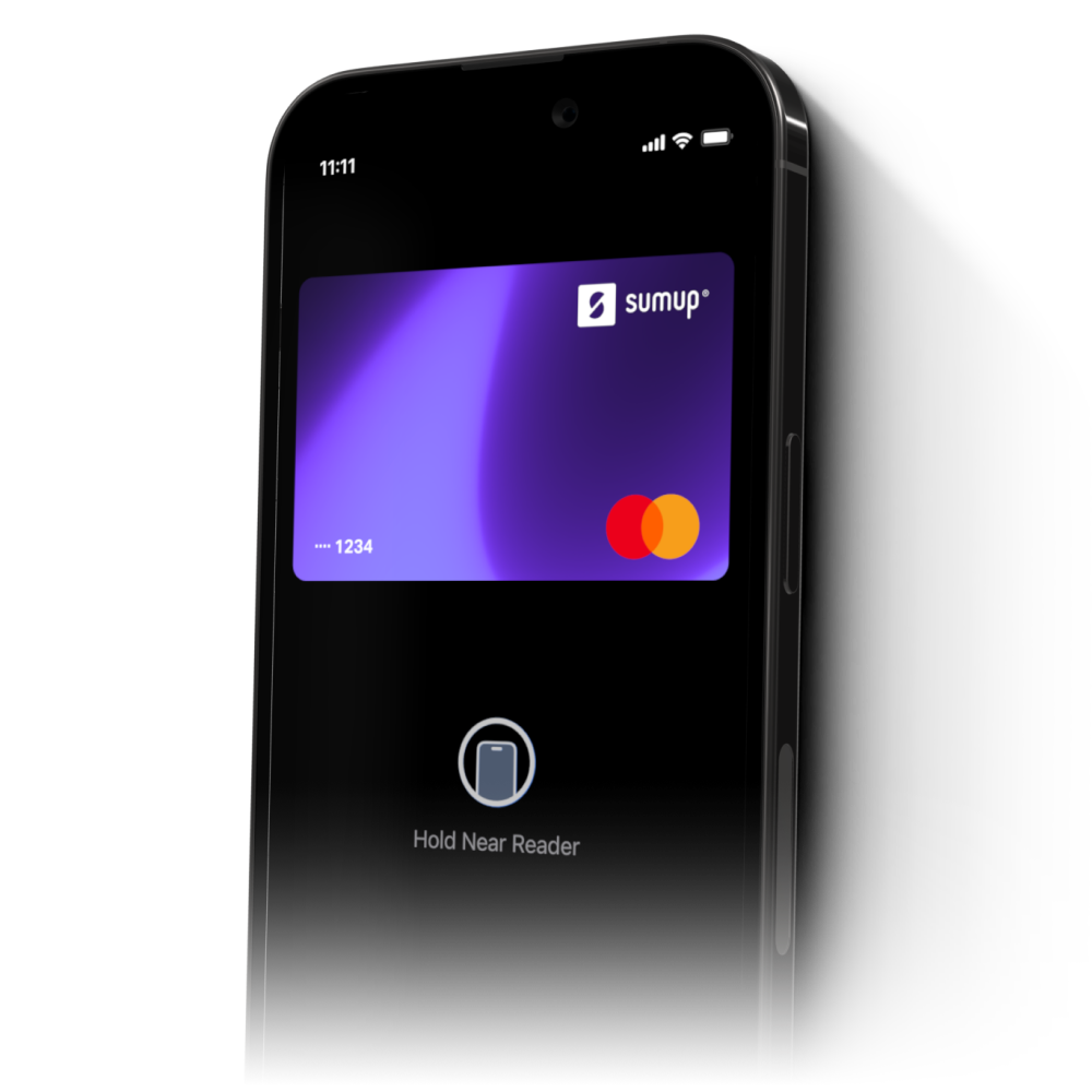 A black phone showing a screen that displays a purple SumUp Pay Mastercard. Below the card is an icon of a phone with the copy ‘Hold Near Reader’