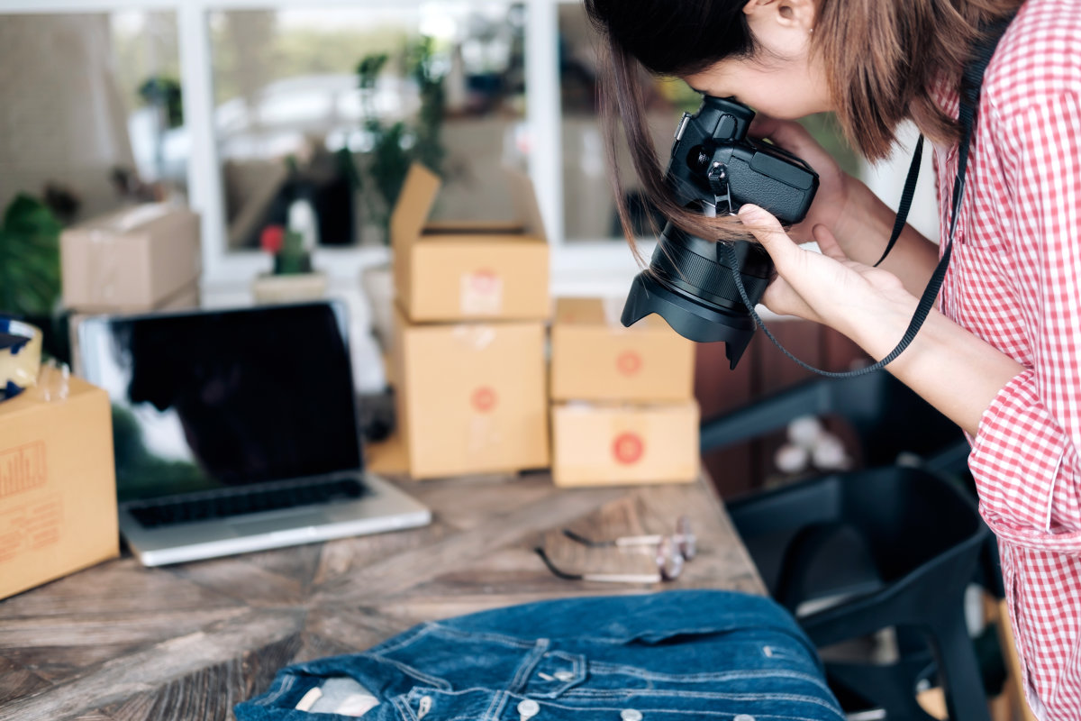 A woman takes photos of products for her e-commerce website.