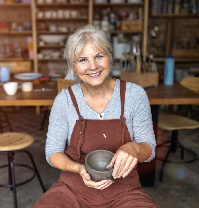Lady sculpting a bowl with her hands