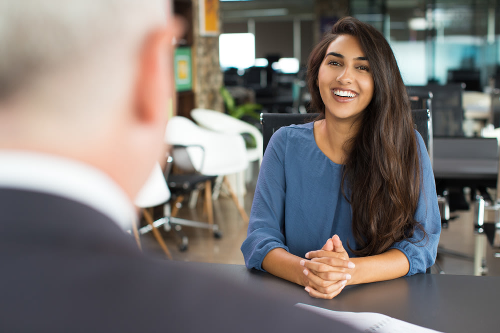 Young female candidate laughing at job interview