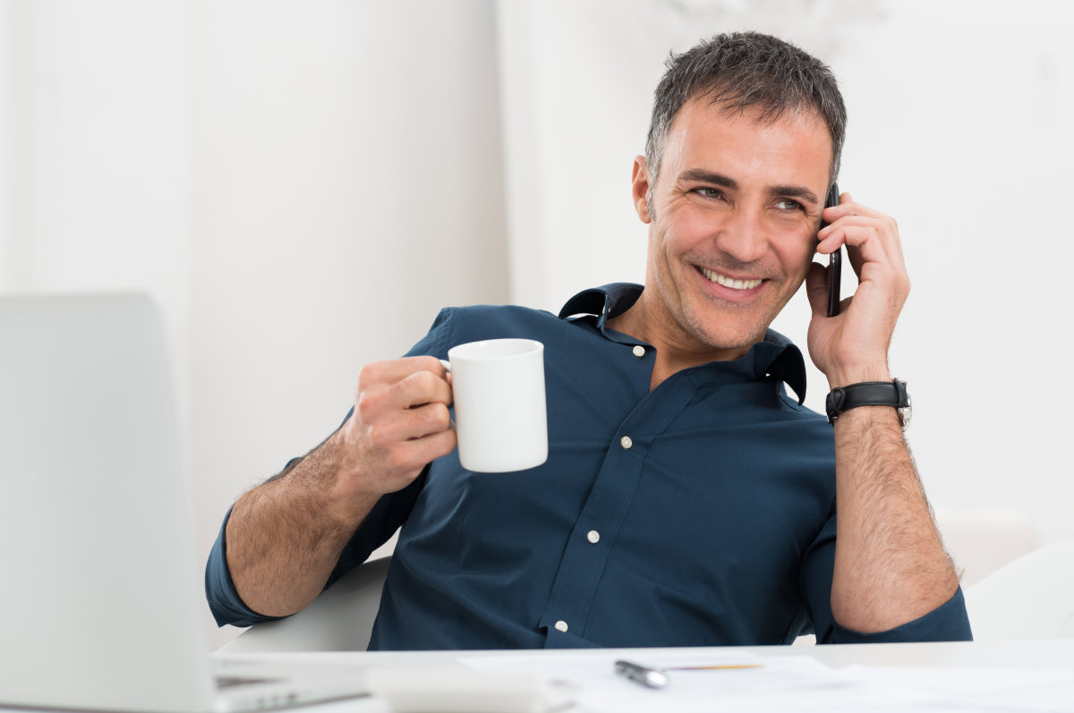 business-owner-on-phone-with-coffee-mug