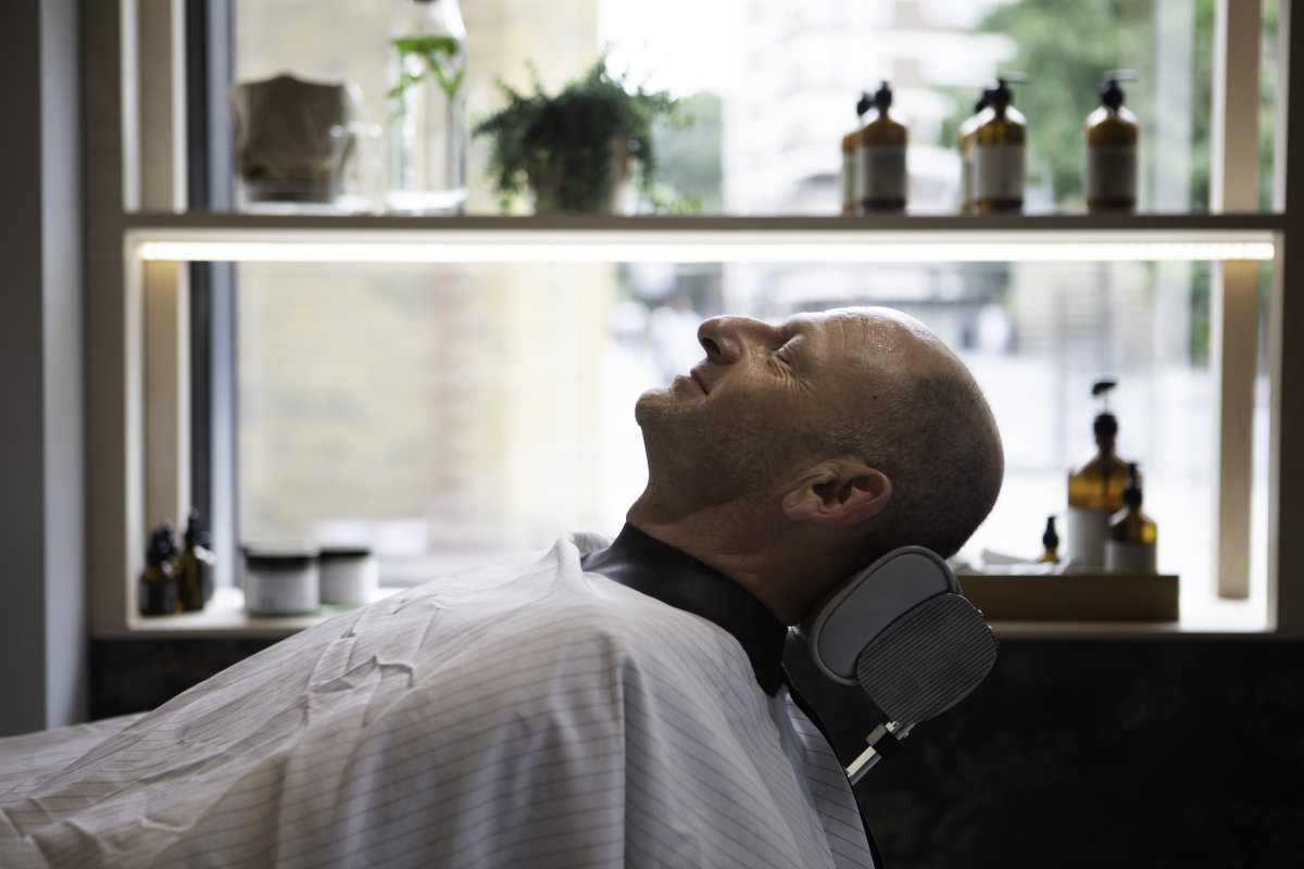 Man being shaved in barber