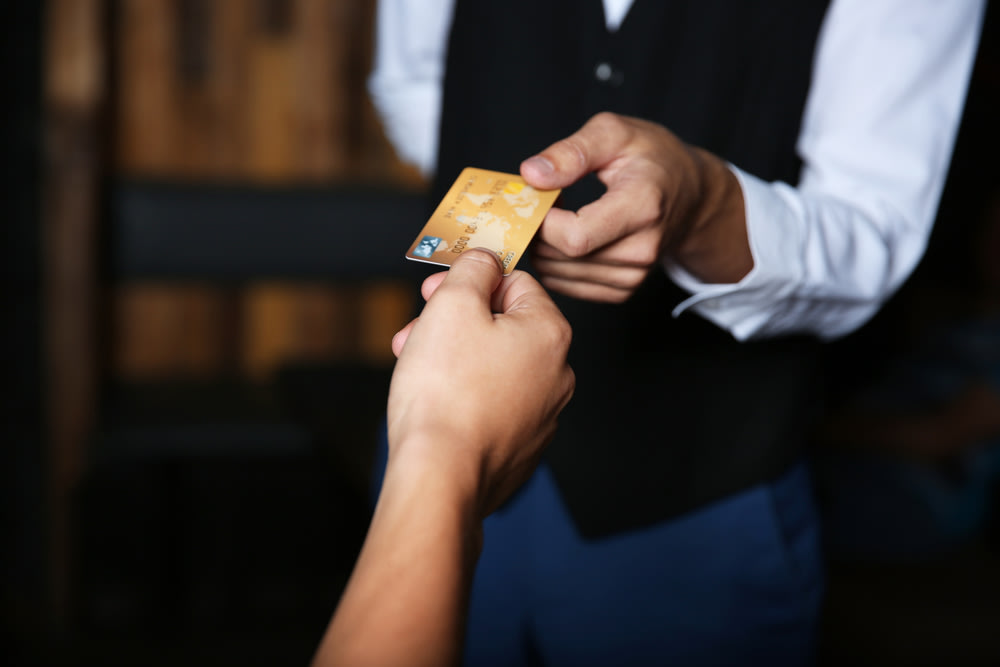 Waiter taking card for tipping.
