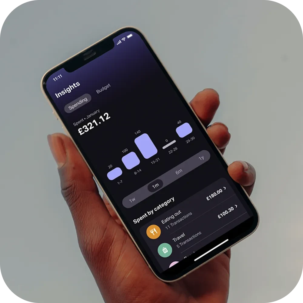 Phone in hand showing spending insights in the app