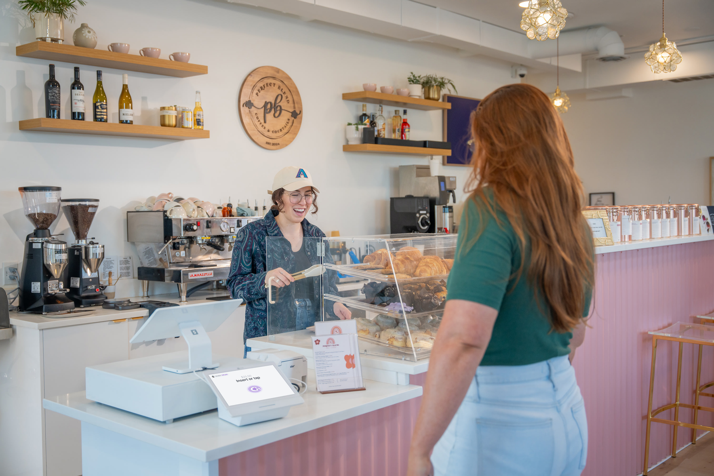 Customer ordering a coffee and pastry from a coffee shop.