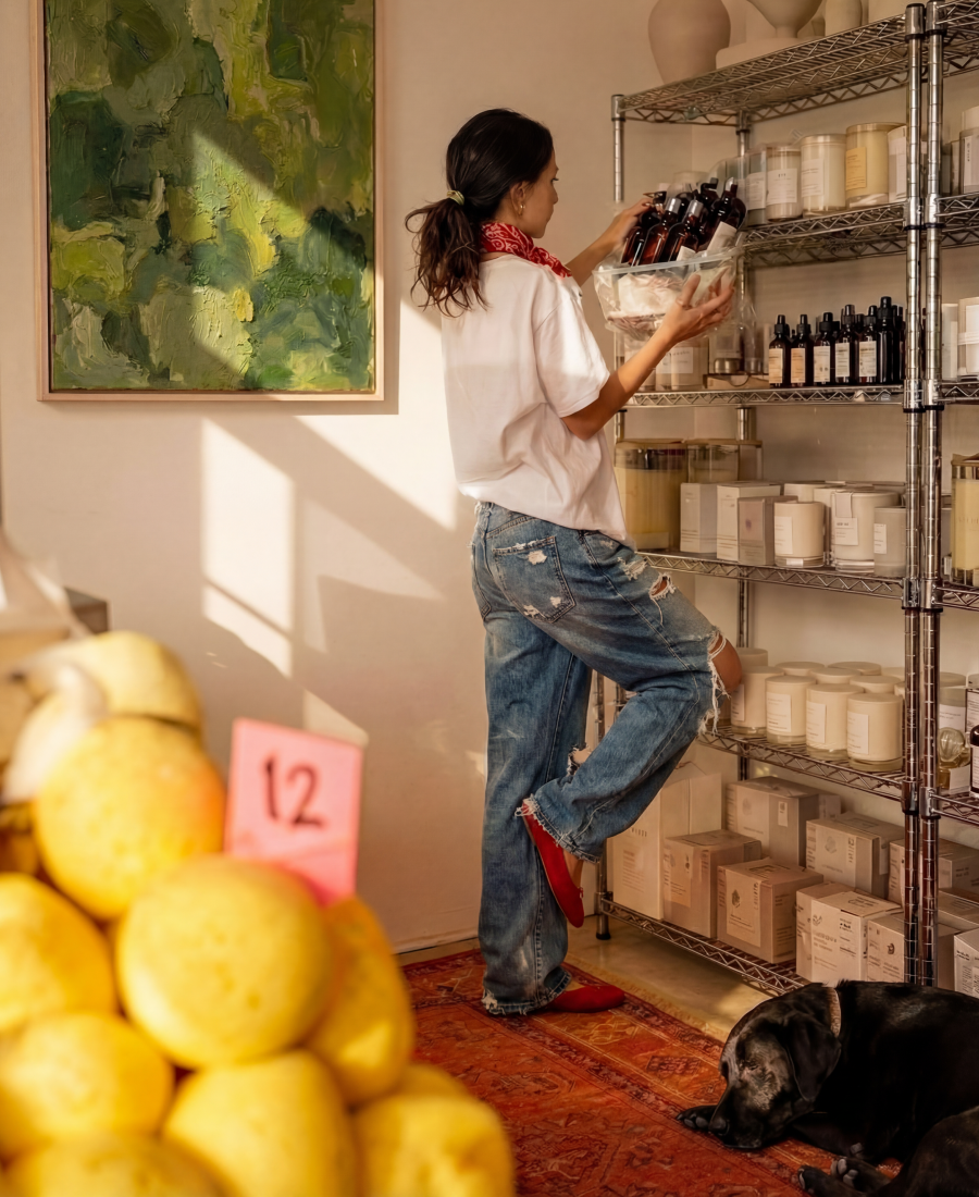 Image showing a person wearing jeans restocking a shelf with bottles
