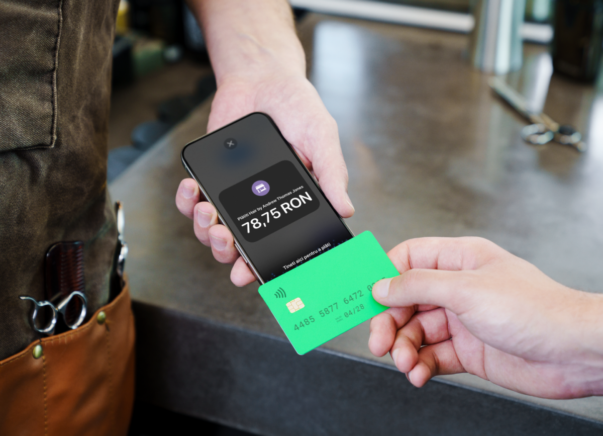 Image of someone tapping their card on an iPhone to pay