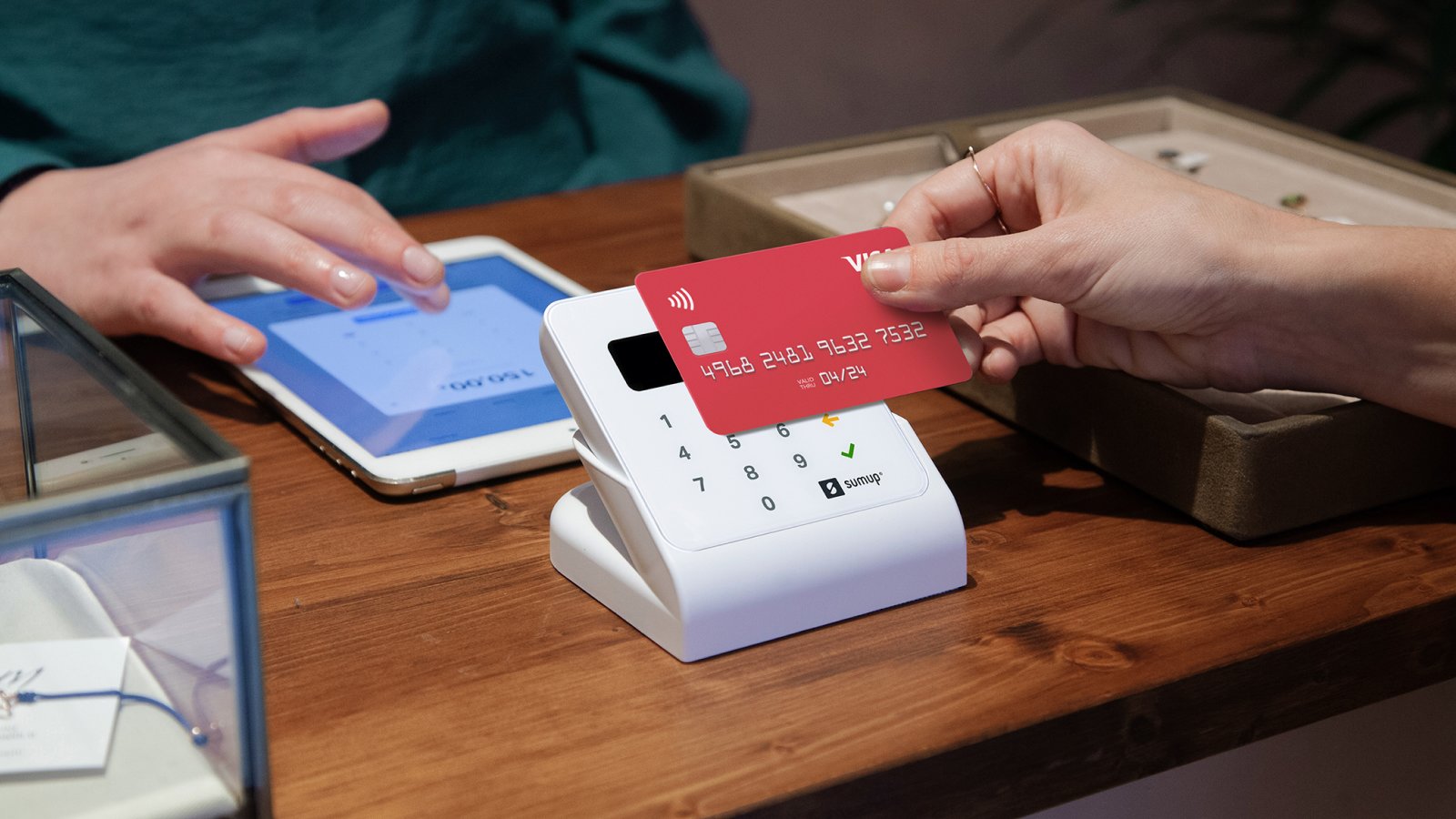 woman pays contactless in a store via a sumup air cardreader