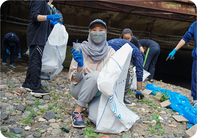 Volunteer working on a river cleanup in Indonesia