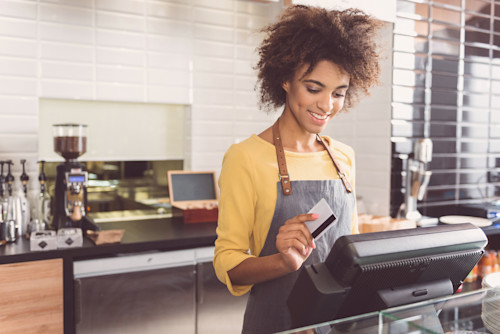 happy cashier taking a payment