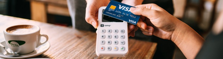 making a card payment with a coffee on the table