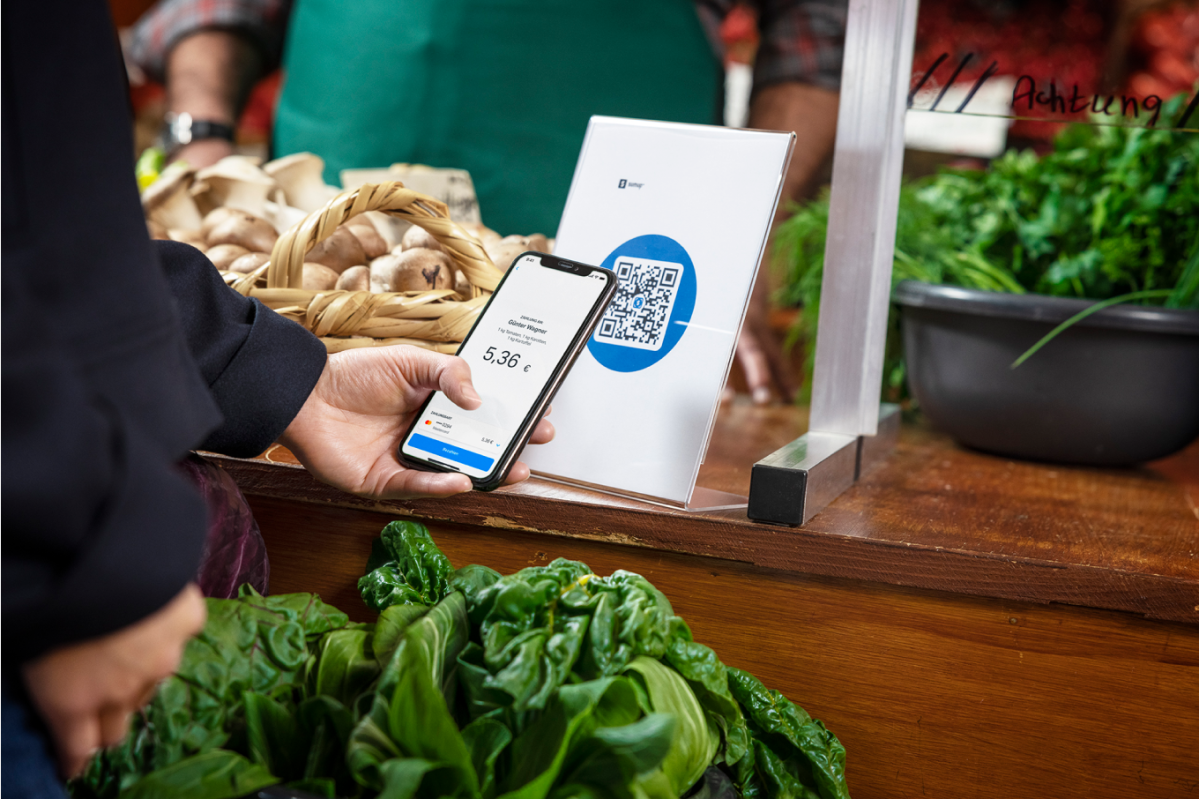 A man scanning SumUp QR code with his mobile phone