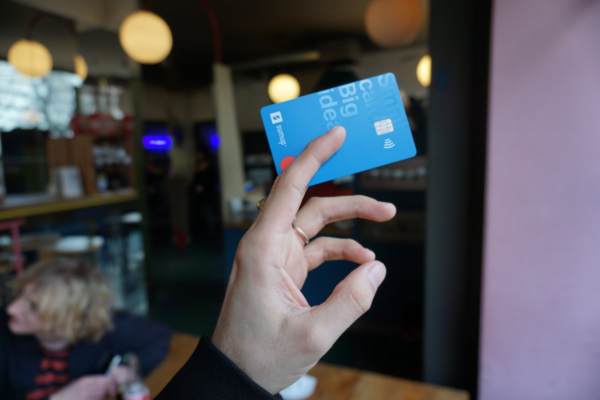 Close-up of woman’s hand holding a SumUp Card