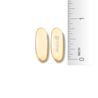 Two oblong, light-yellow Motrin IB liquid gel caplets are shown next to a ruler. The ruler shows that the caplets are approximately Â¾ inch long.