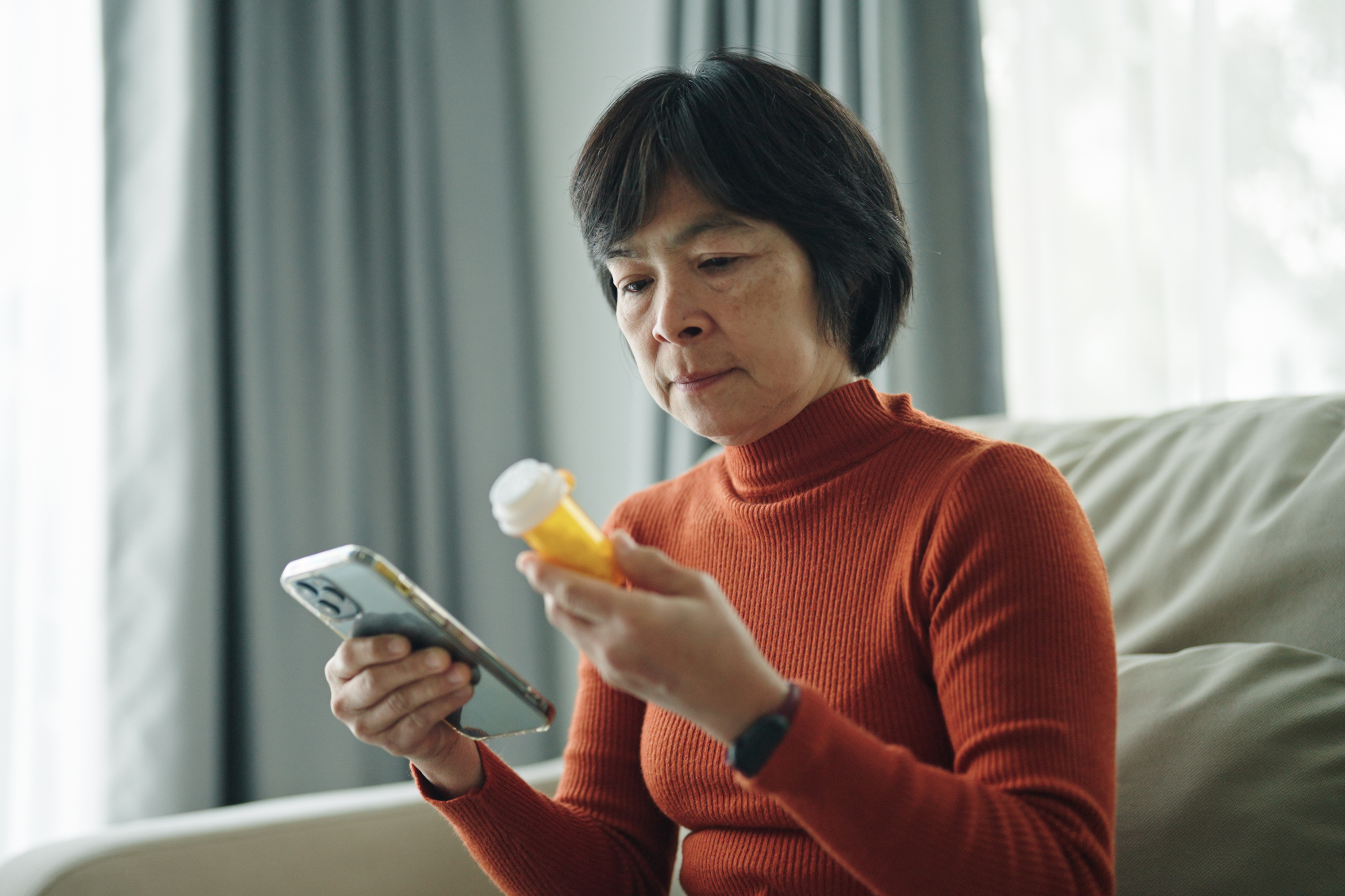 Person reading a prescription drug bottle