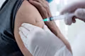Close up view of an elderly man getting vaccine shot in his arm
