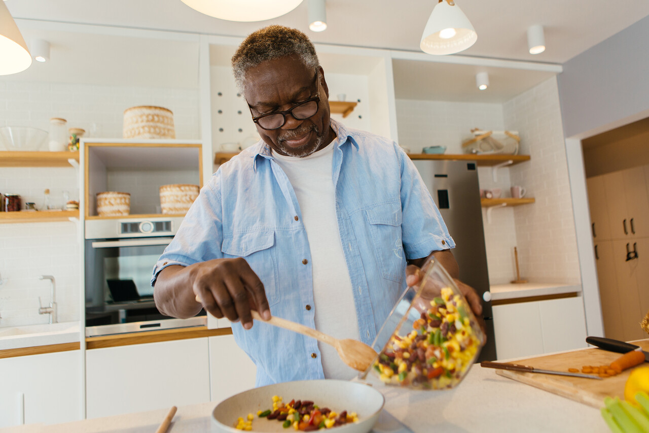 Senior man cooking in kitchen