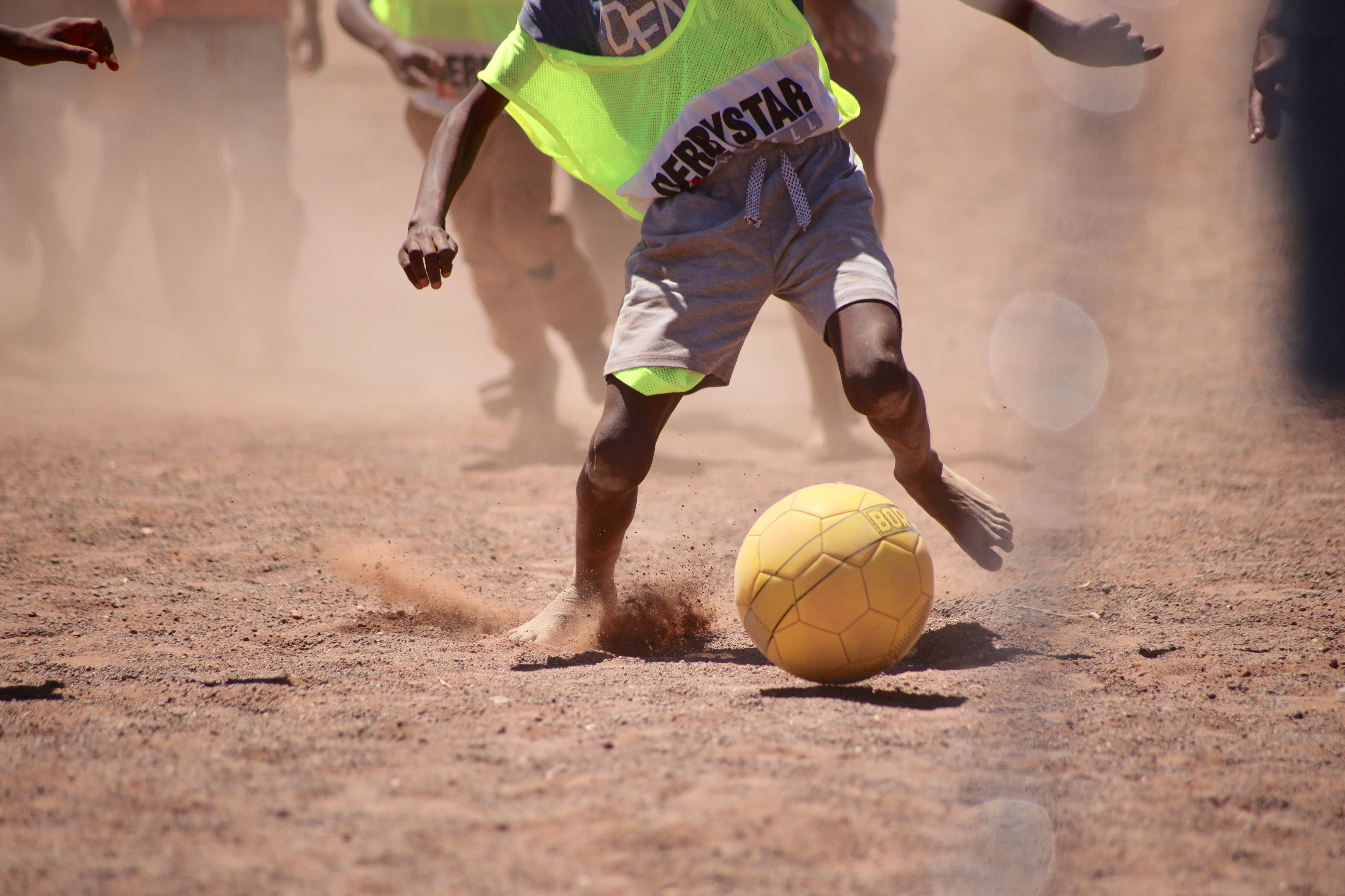 Children in Rwanda playing soccer with handmade balls