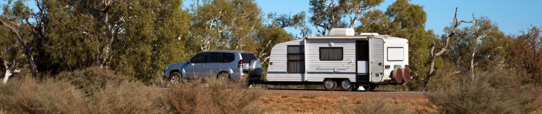 Shine Lawyers | Car and caravan travelling in the Australian bush | Shine Lawyers