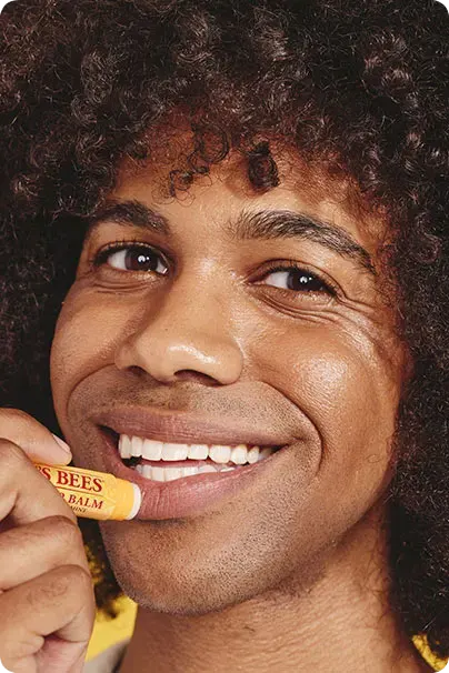 man using burt's bees lip balm