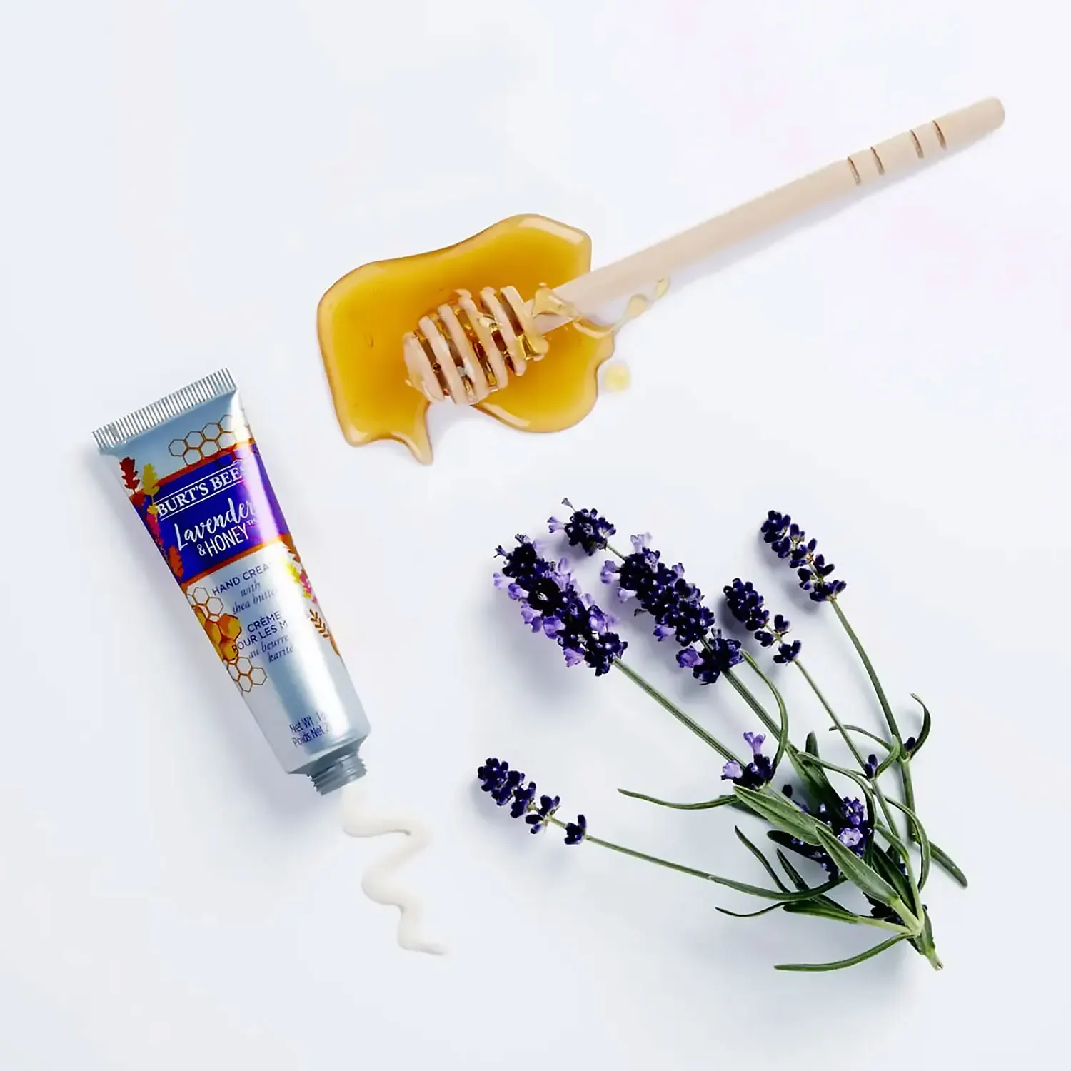 lavender & honey hand cream with honey dripper and lavender sprig