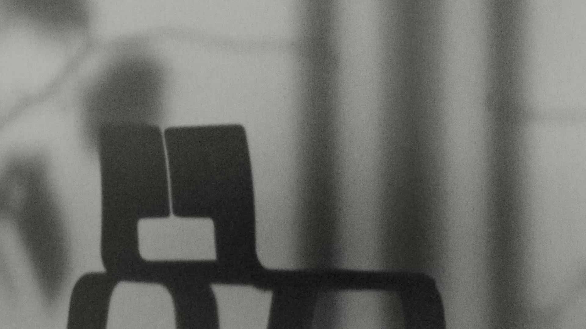 The shadow of a chair designed by Charlotte Perriand.