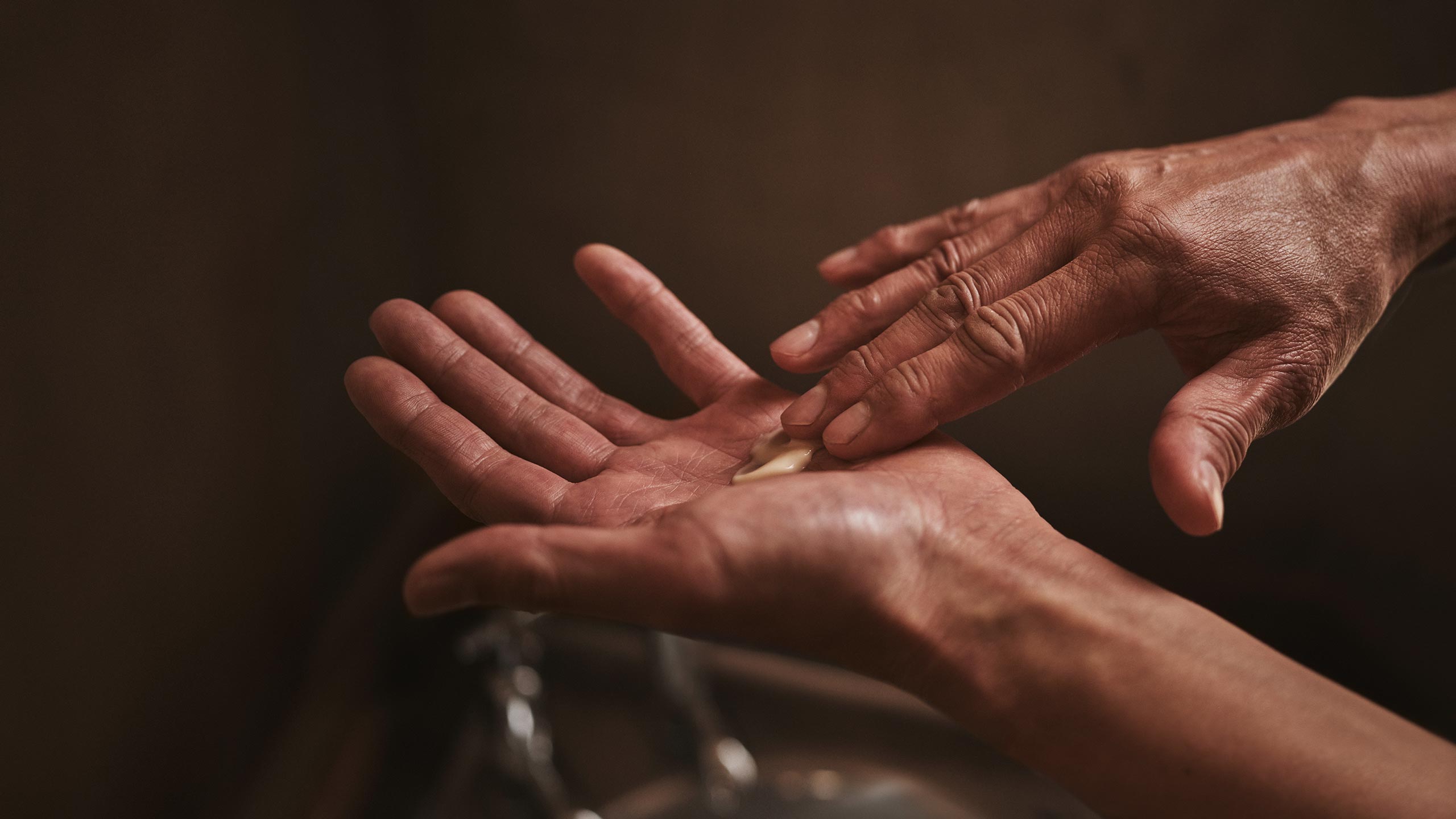 A pair of hands preparing to apply Sublime Replenishing Night Masque.