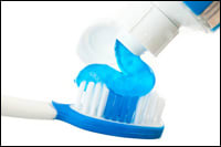 Photo of fluoride toothpaste being put on a toothbrush.