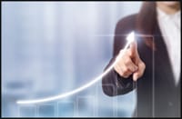 Business woman showing upward growth motion on a bar graph.