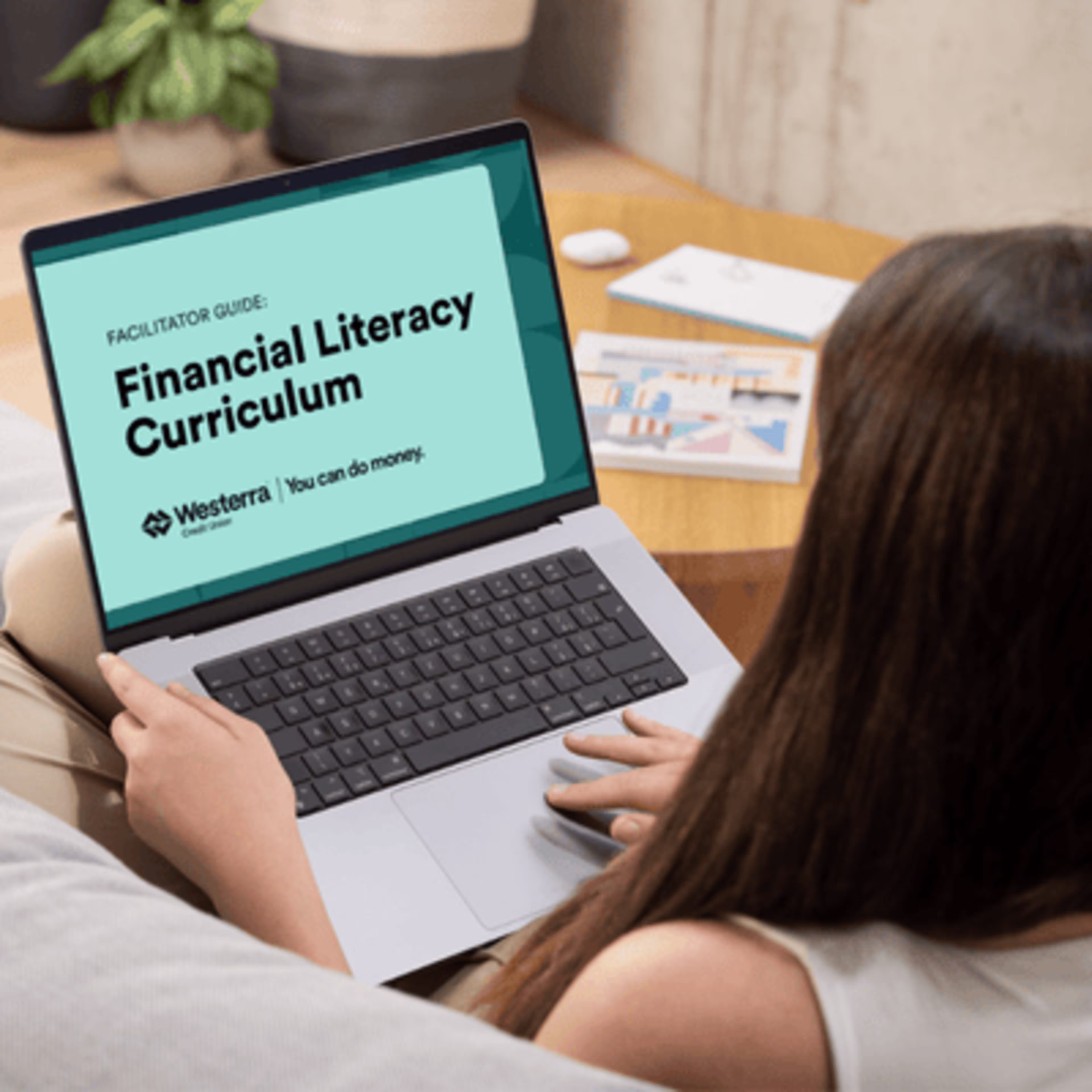 Westerra Credit Union Offers a full financial literacy curriculum that aligns with Colorado State standards. Photo representing educator downloading Westerra's Curriculum.