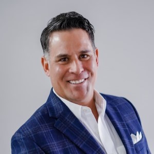 Jerad Varoz is a Mortgage Loan Officer at Westerra Credit Union. He's wearing a blue suit jacket.