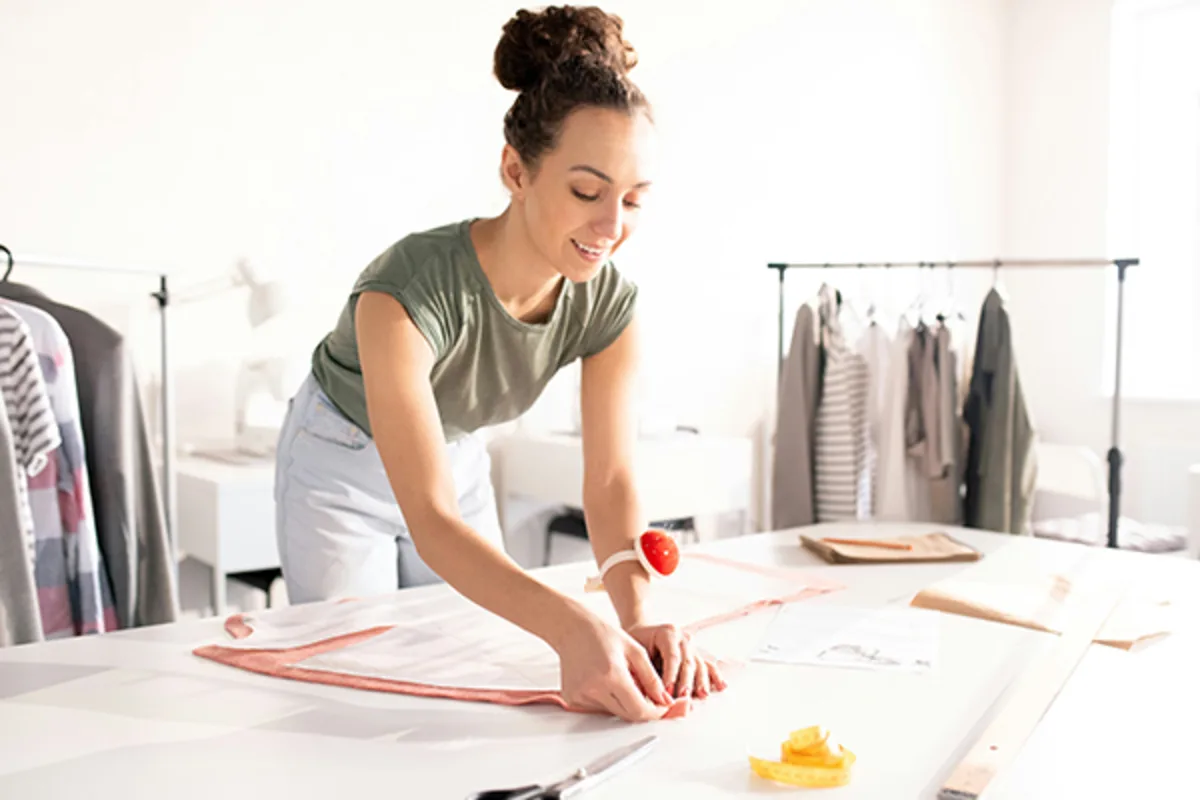 Woman sewing in a small business setting, representing Colorado entrepreneurs using Westerra’s small business online banking and online bill pay service to manage finances securely and efficiently.