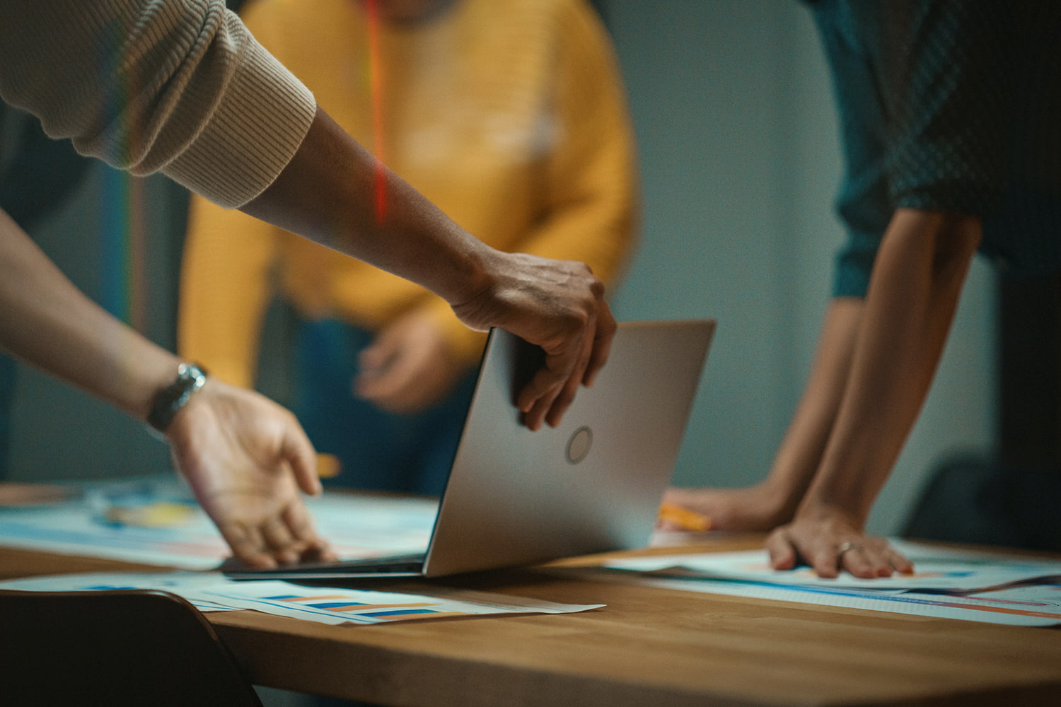 Closeup of hands holding a laptop open