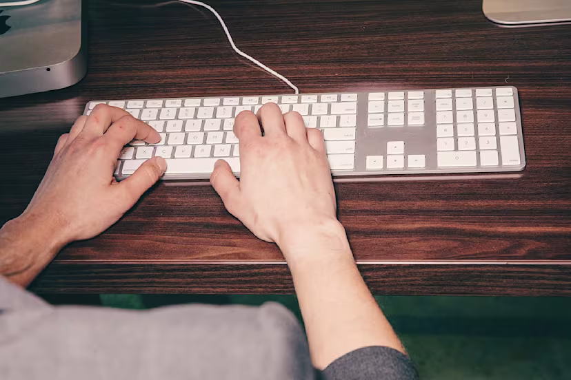 Person typing on a keyboard