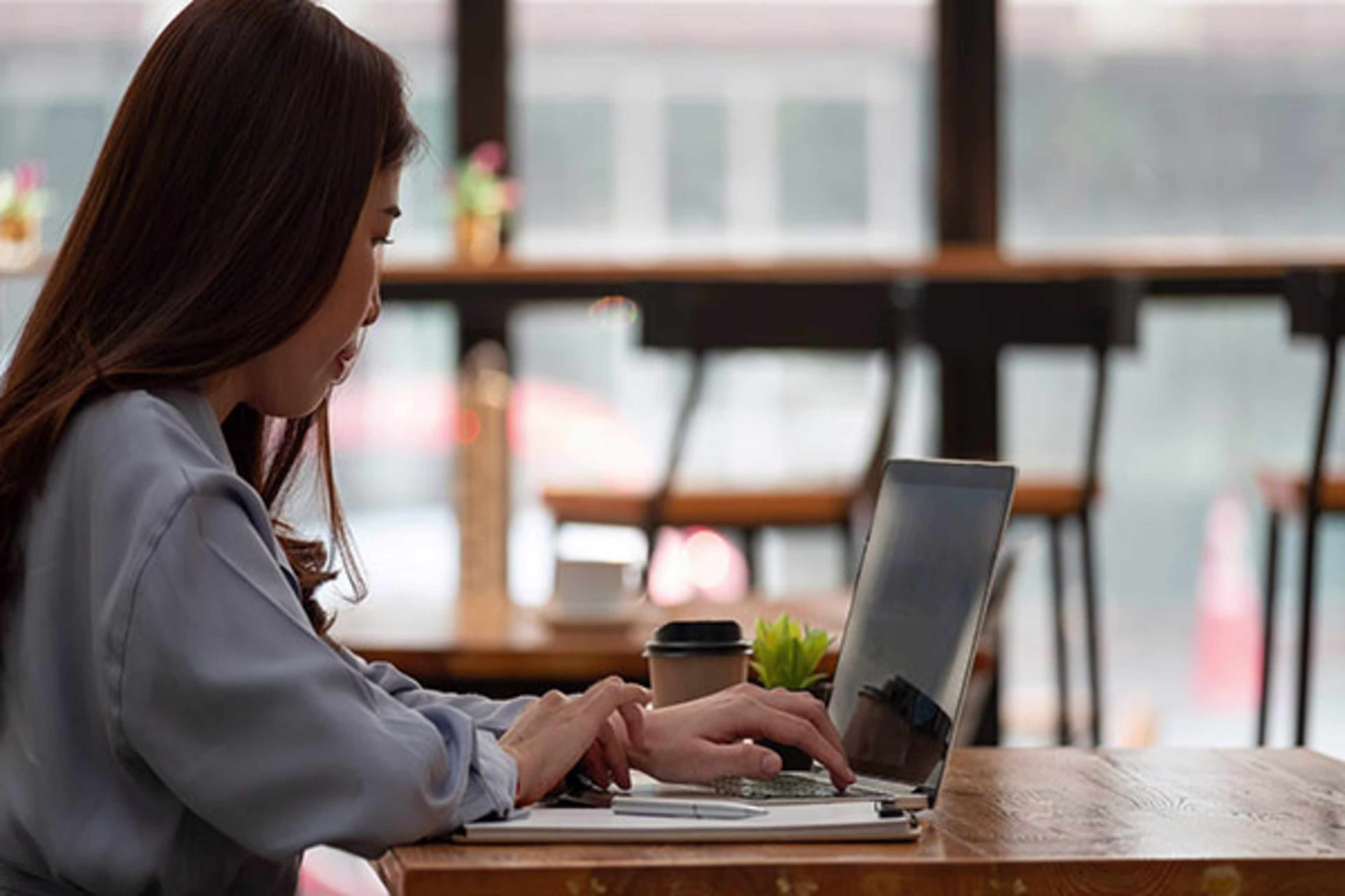 Woman on computer attending a fraud seminar.