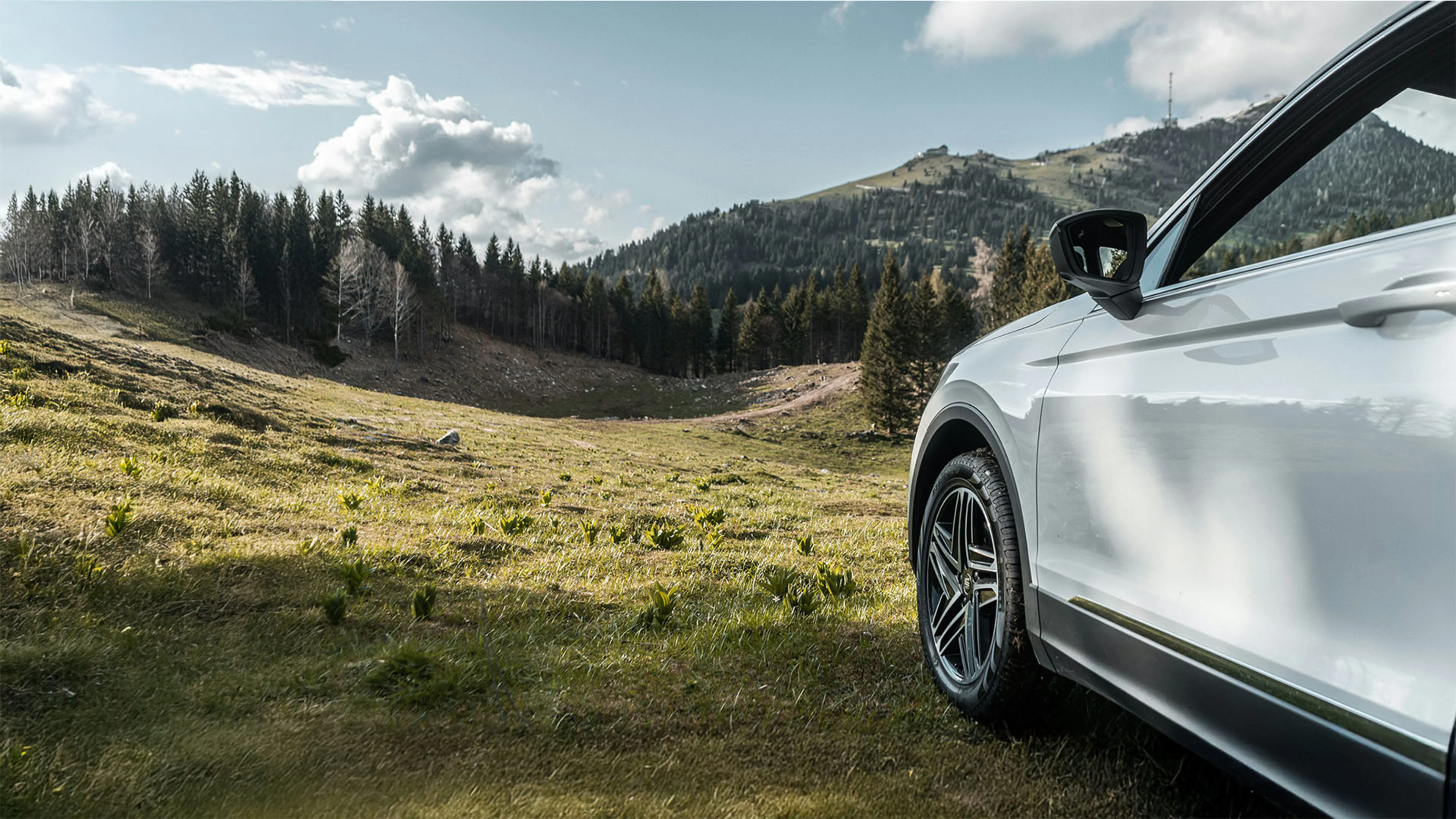 Business vehicle driving through mountain landscape, financed with Westerra Business Auto Loans.