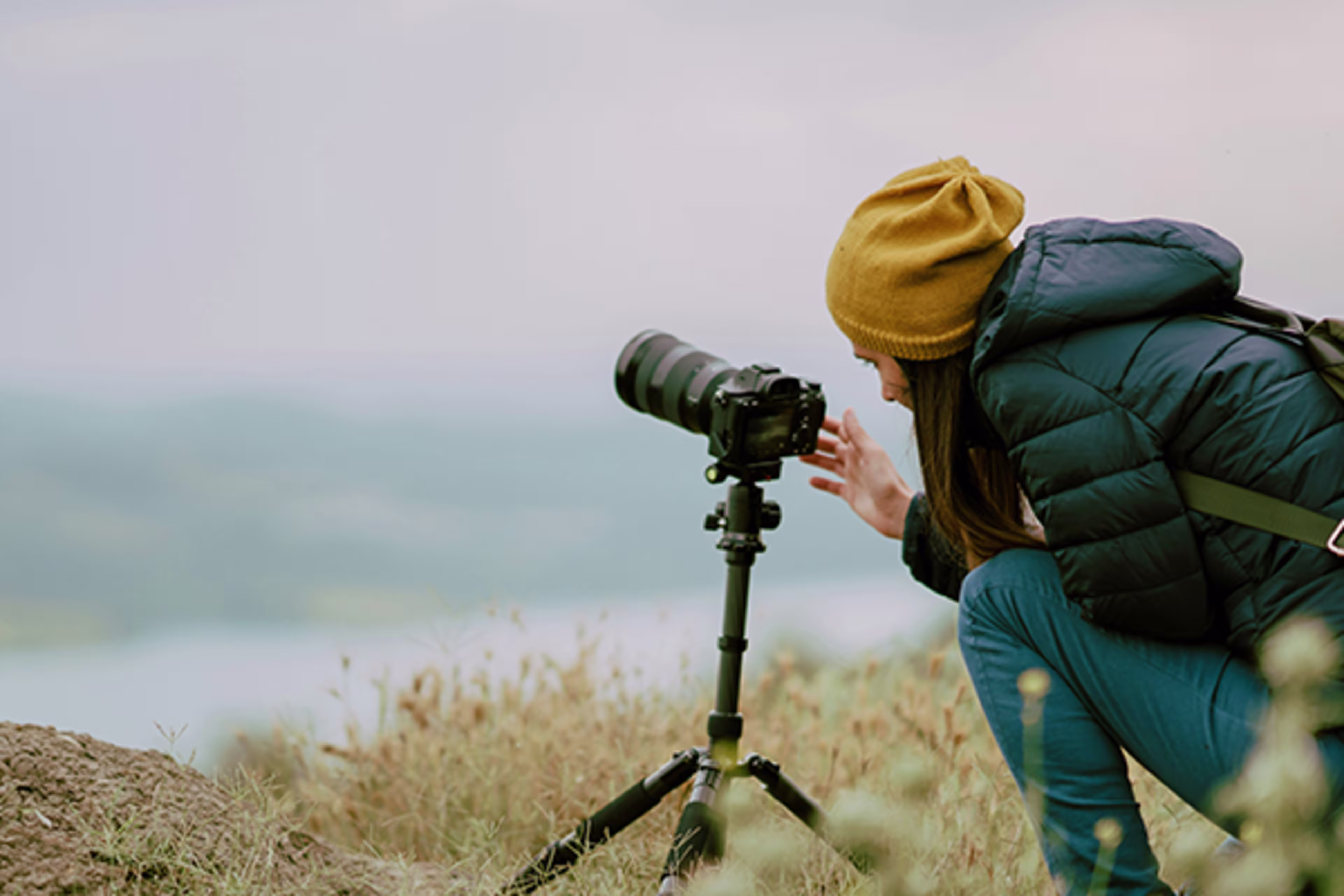 Female photographer capturing images, supported by Westerra Business Credit Cards for her small business finances.
