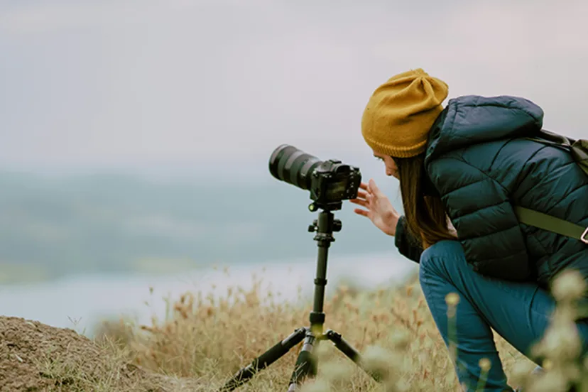 Female photographer capturing images, supported by Westerra Business Credit Cards for her small business finances.