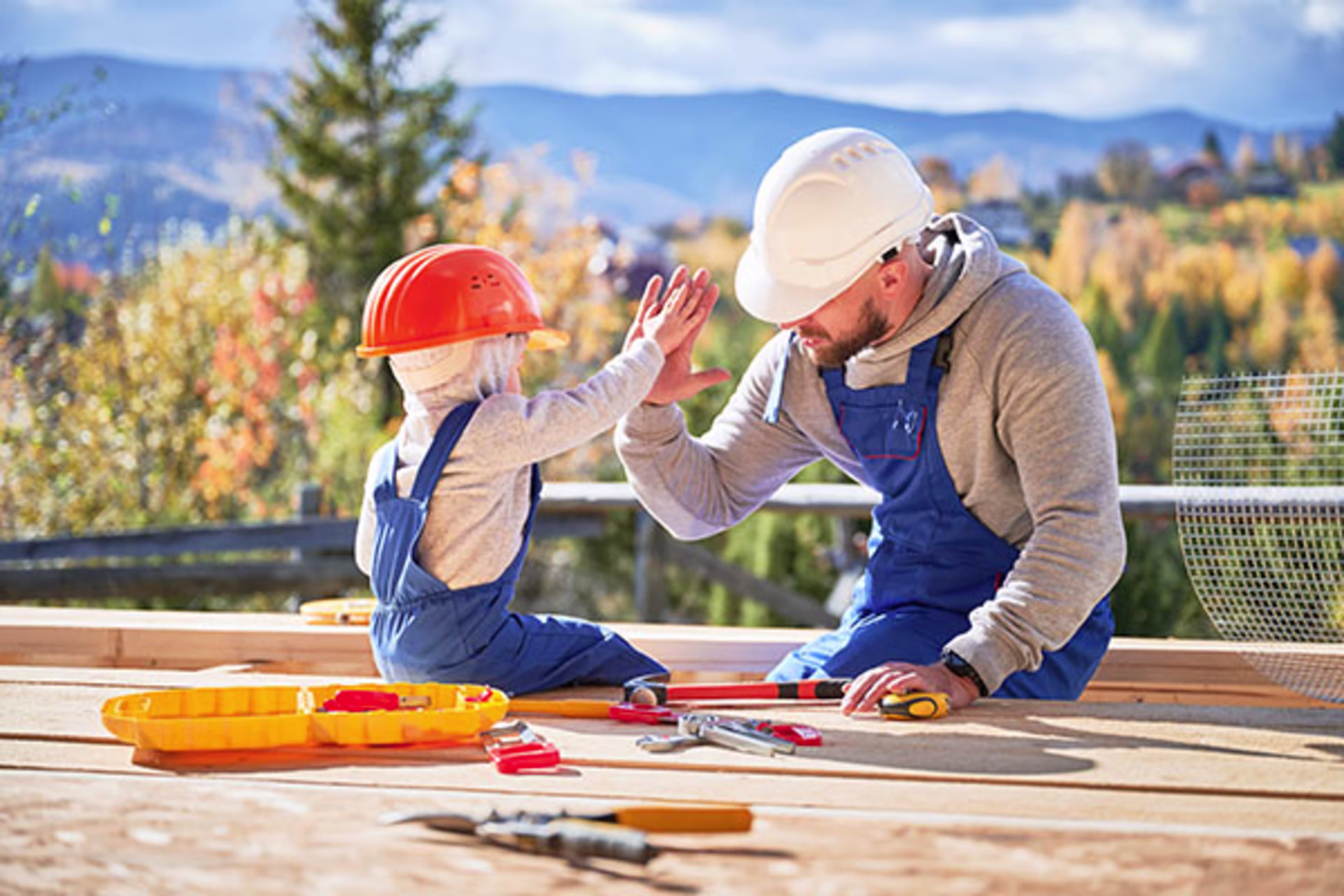Father and son working on a home improvement project together, representing family involvement in renovations—perfect for illustrating topics like home improvement, construction loans, and home improvement loans.