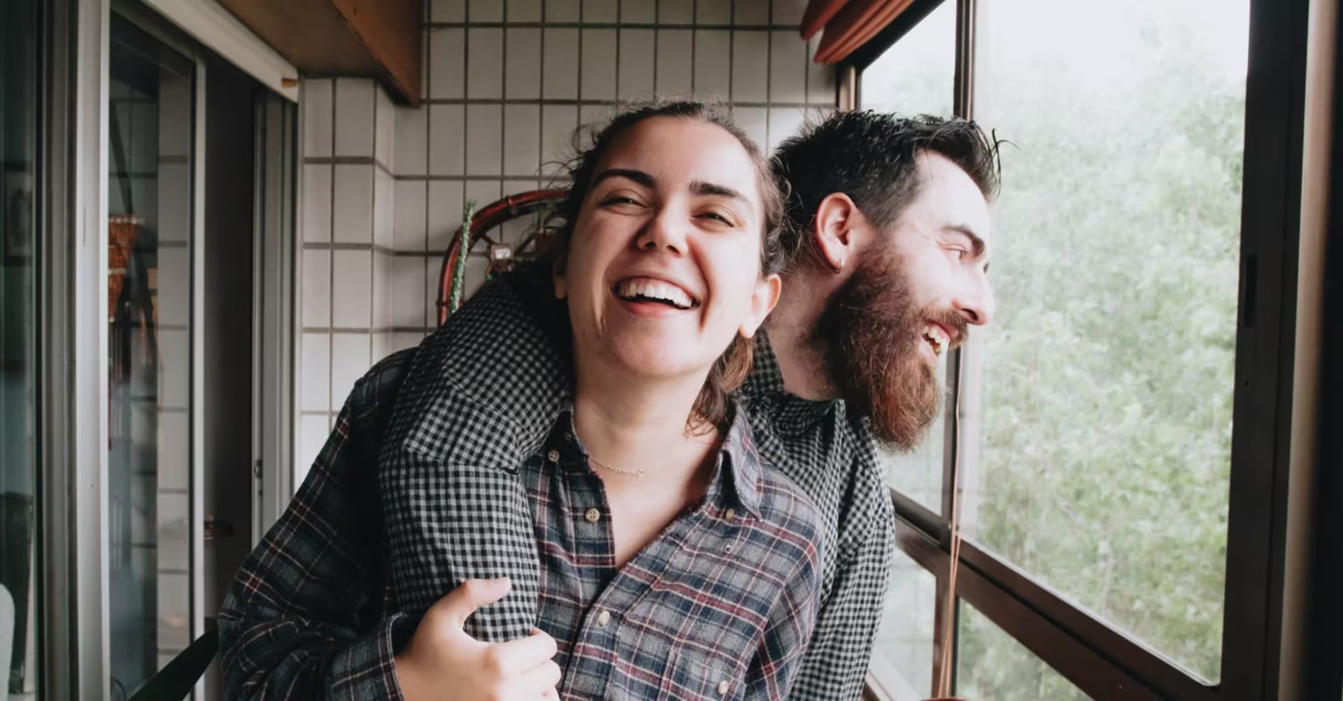 Happy couple looking out window