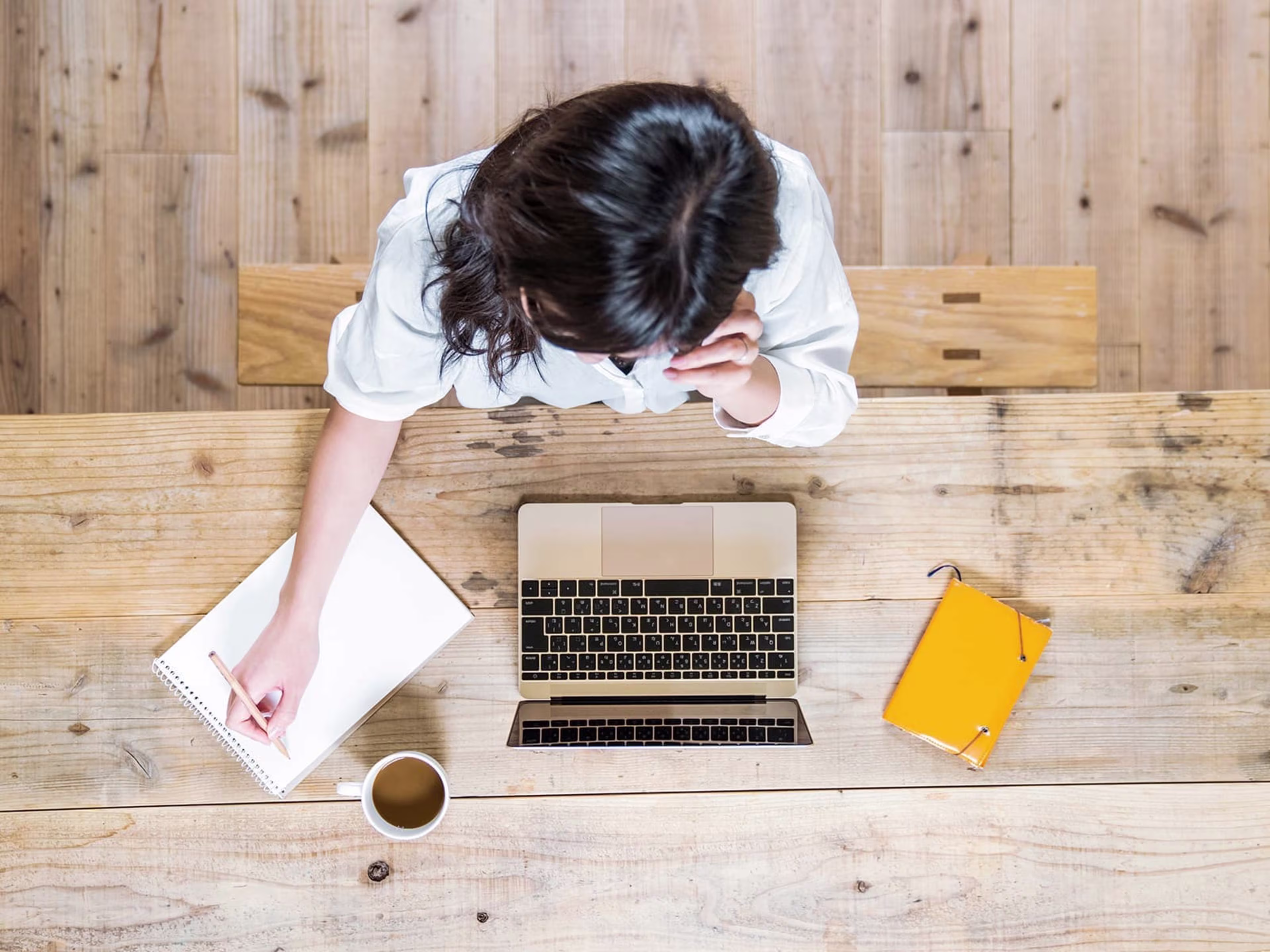 Woman sitting at a table doing bookkeeping