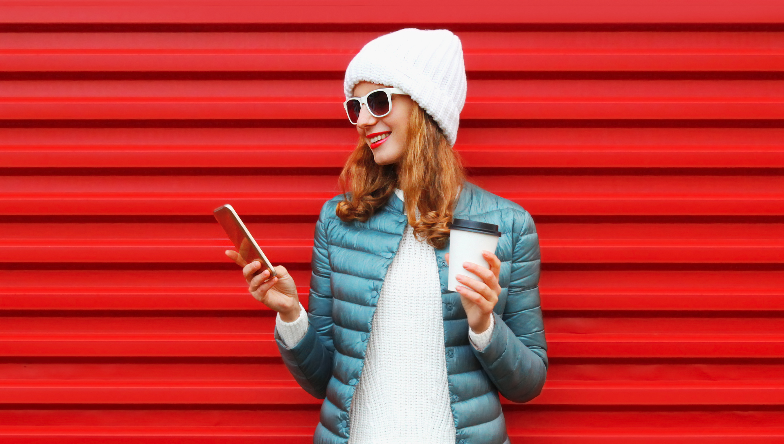 Lady in red jacket holding a phone